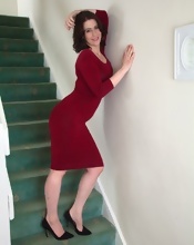 Busty MILF gets naked on stairs in the hairy pussy pics